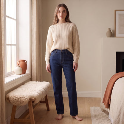 Juno dark wash straight leg jeans worn with a cream knit sweater by The Lode Lane