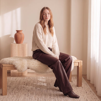 Simone burgundy faux-leather wide-leg pants seated by The Lode Lane
